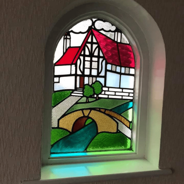 Stained glass scene in arch window