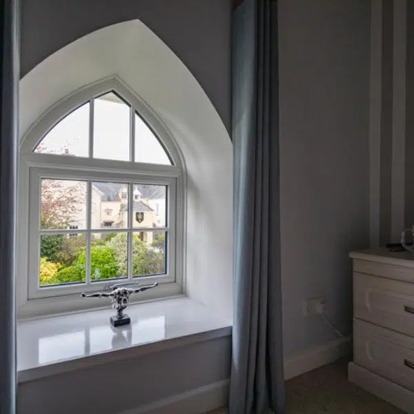 interior view of uPVC double glazed shaped window in a bedroom